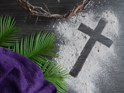 Ashes on table with cross symbol and palm fraunds