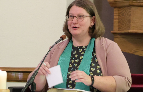 Photo of Ashley Birk in pulpit of prior church