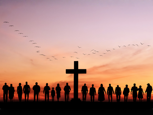 Cross in sunset with people silhouettes around it