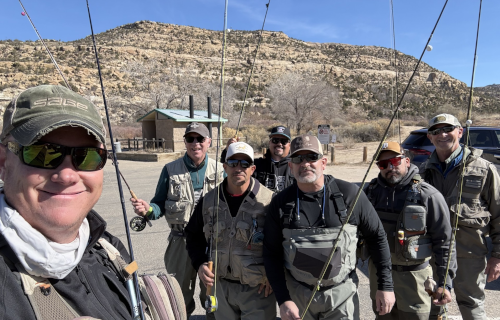 Rev. Andrew Black and other men standing with fishing poles