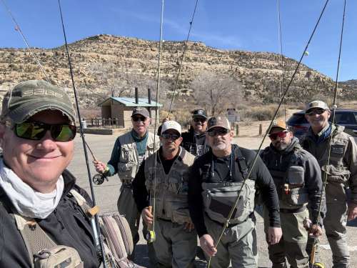 Rev. Andrew Black and other men standing with fishing poles