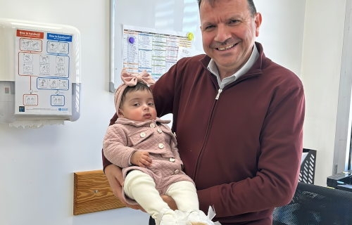 Doctor smiling and holding baby girl