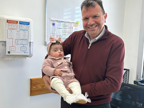 Doctor smiling and holding baby girl