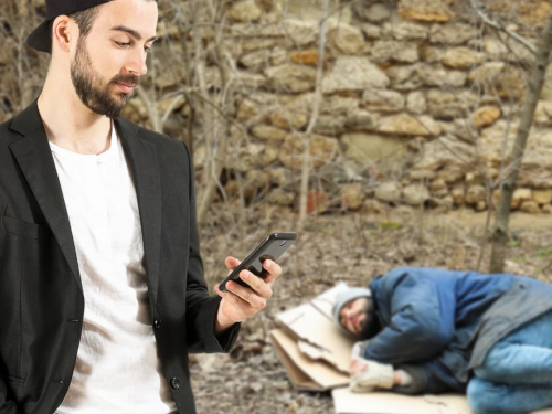 Man standing next to homeless man on the ground sleeping
