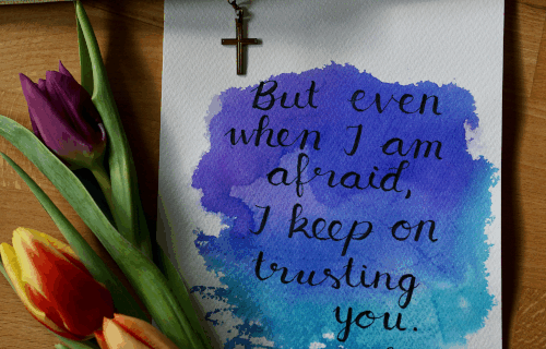 A note with the text "But even when I am afraid, I keep on trusting you." with tulips in purple, red, and yellow. A cross is above the note.