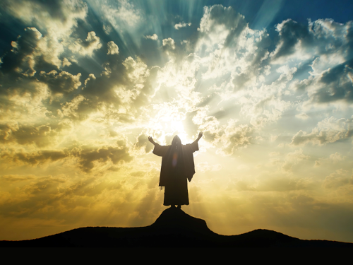 Prophet standing on mountain with arms up to sky