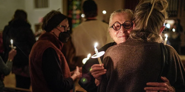 Women hugging at vigil