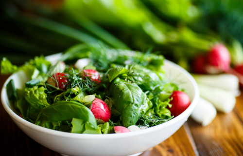 Salad bowl filled with greens and vegetables