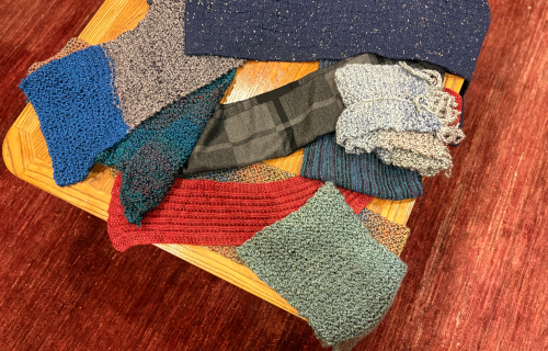 Colorful knitted scarves lying on a table