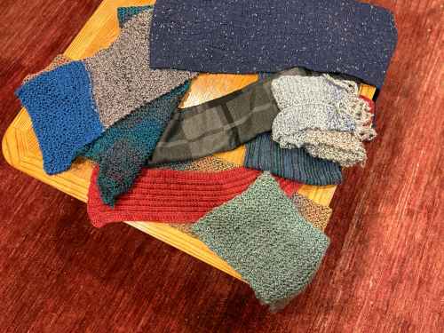 Colorful knitted scarves lying on a table