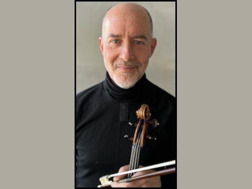 Stephen Redfield in a black shirt holding a violin