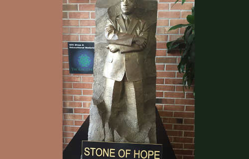 Small statue of Martin Luther King Jr. and sign "Stone of Hope"