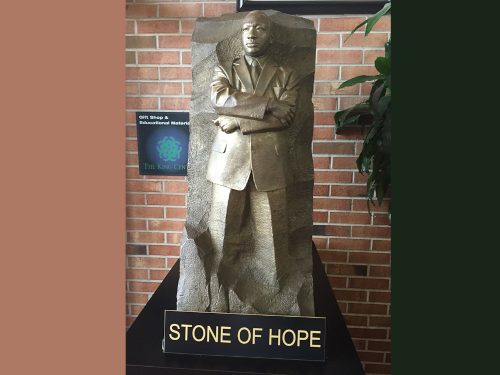 Small statue of Martin Luther King Jr. and sign 