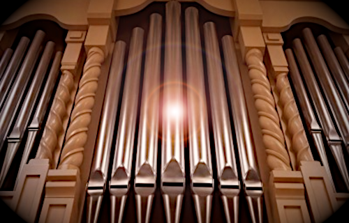 Close up of pipes of FPC organ, with a glow