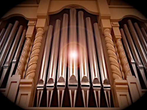 Close up of pipes of FPC organ, with a glow